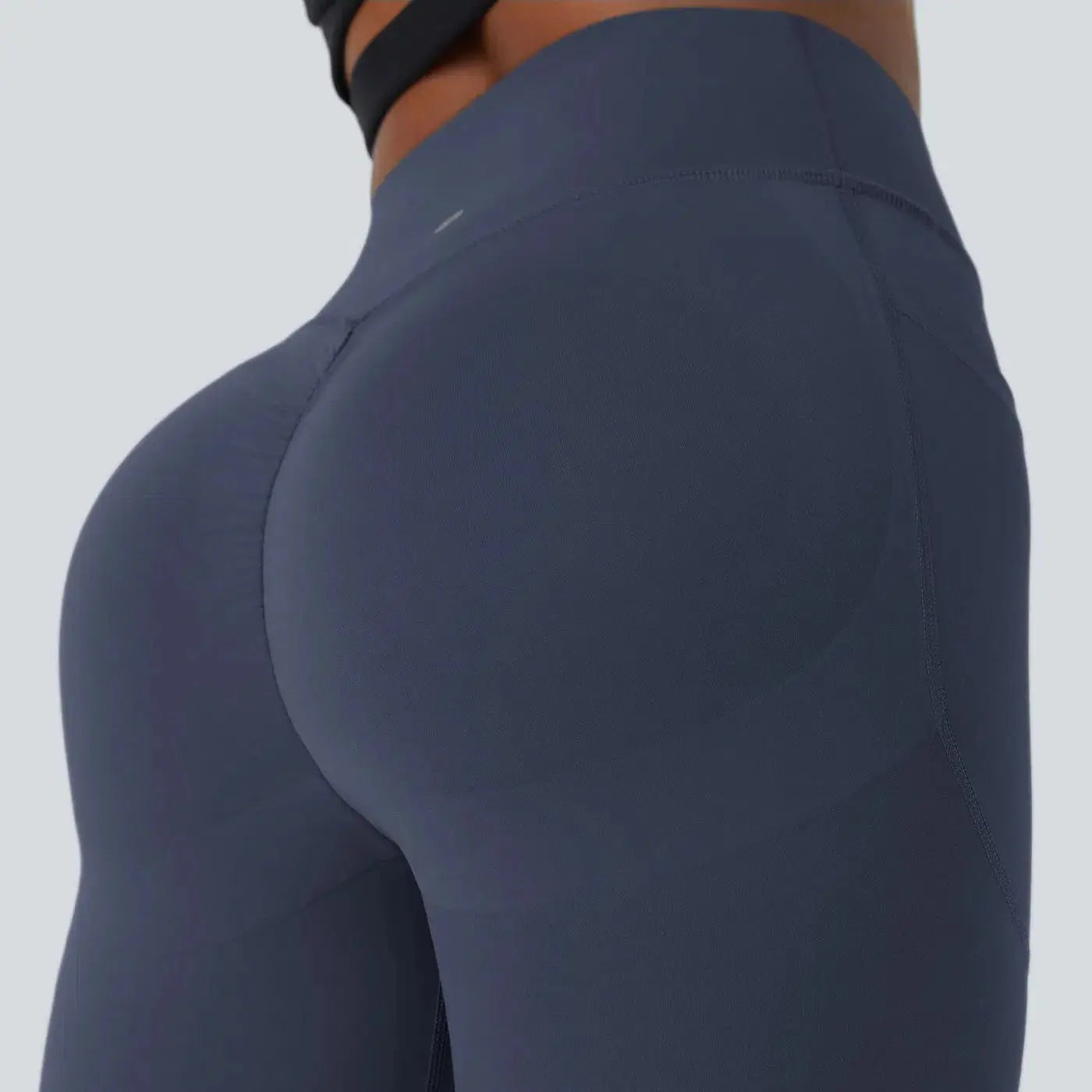 Seamless scrunch leggings close-up showing ruched seam butt lift detail
